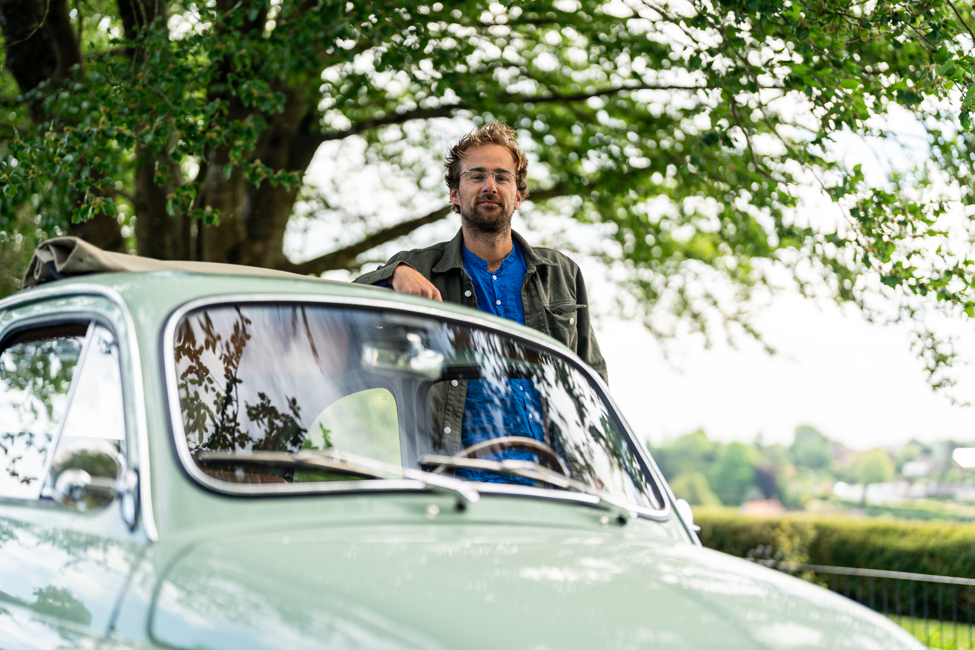 Jack, founder and CEO of Silent Classics, leaning against a classic Fiat 500